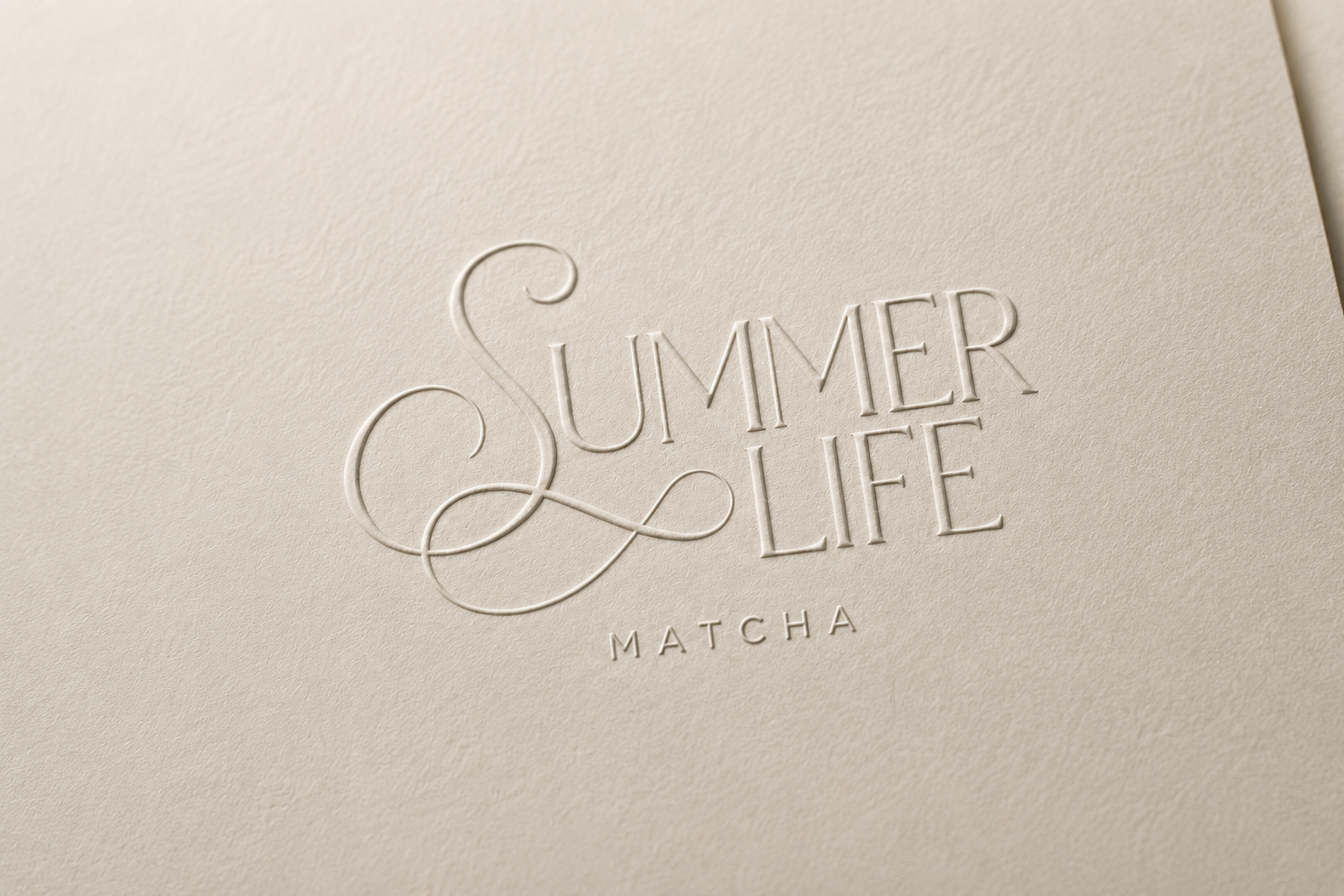 Close-up of the embossed Summer Life Matcha wordmark on cream cardstock